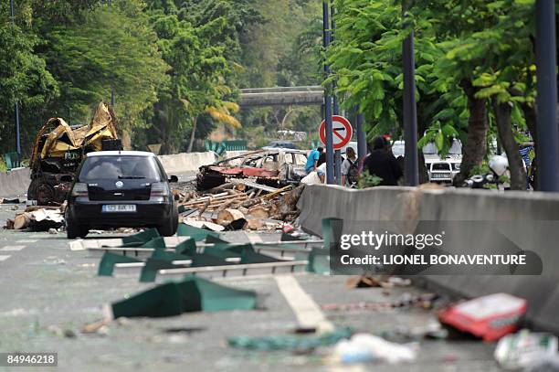 Locals try to pass by a barricade on February 20, 2009 in Pointe-a-Pitre, on the French Caribbean island of Guadeloupe, on a urban motorway littered...