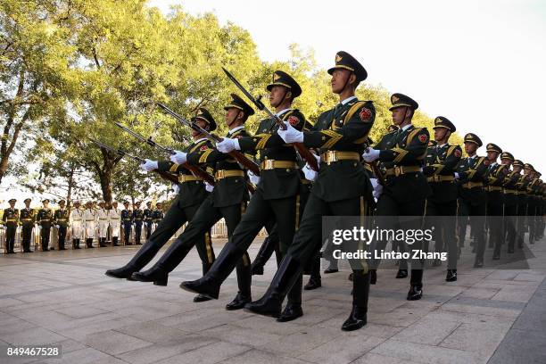 Members of an honor guard march during a welcoming ceremony for Singapore Prime Minister, Lee Hsien Loong outside the Great Hall of the People on...
