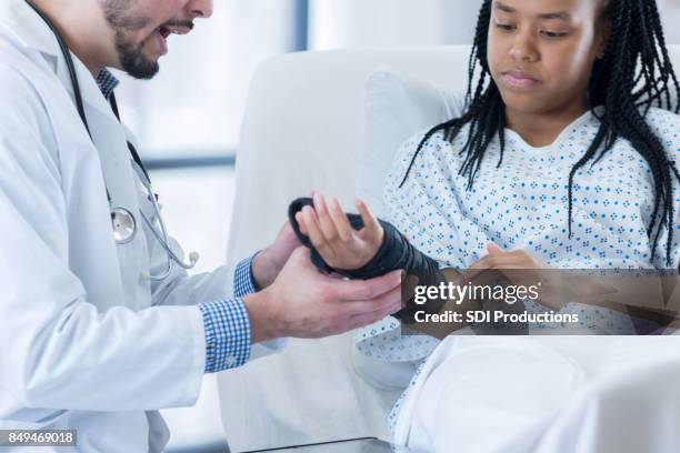 teen hospital patient learns how to wear wrist brace - sprain stock pictures, royalty-free photos & images
