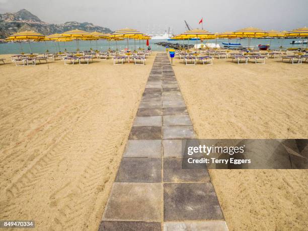 beach scene at giardini naxos, taormina. - naxos sicily stock pictures, royalty-free photos & images