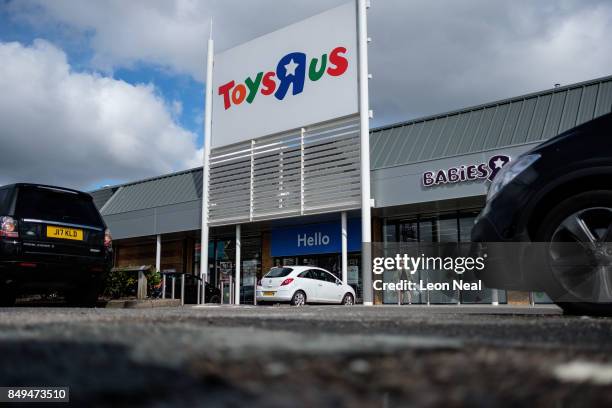 Customers walk towards a branch of the toy store Toys R Us on September 19, 2017 in Luton, England. The company has struggled to compete against...