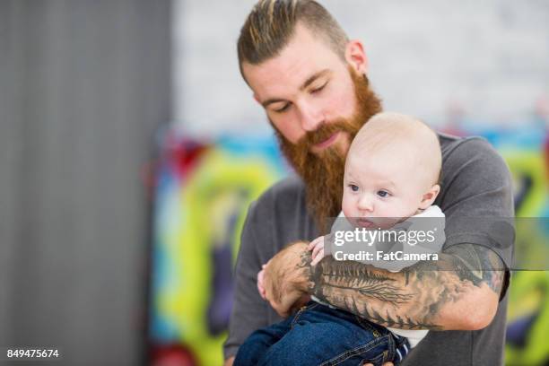 tattooed dad with baby boy - mom-and-son-tattoo-designs stock pictures, royalty-free photos & images