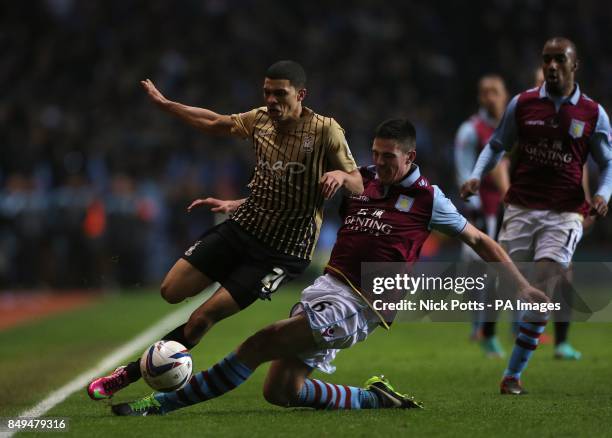 Aston Villa's Ciaran Clark and Bradford City's Nahki Wells battle for the ball