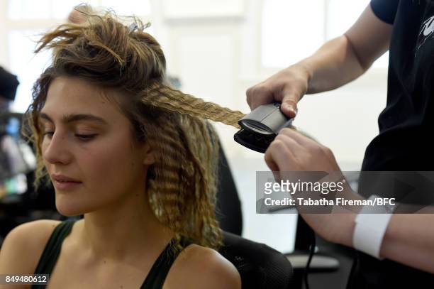 Model has their hair styled backstage ahead of the palmer//harding show during London Fashion Week September 2017 on September 19, 2017 in London,...