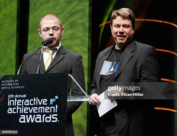 Video game designer Toby Gard and chief creative officer and co-founder of Big Red Button Entertainment Dan Arey present an award at the Academy of...