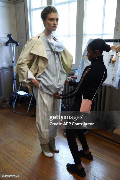 Stylists prepare models backstage ahead of the catwalk show of palmer//harding during the Spring/Summer 2018 collection on the fifth and final day of...