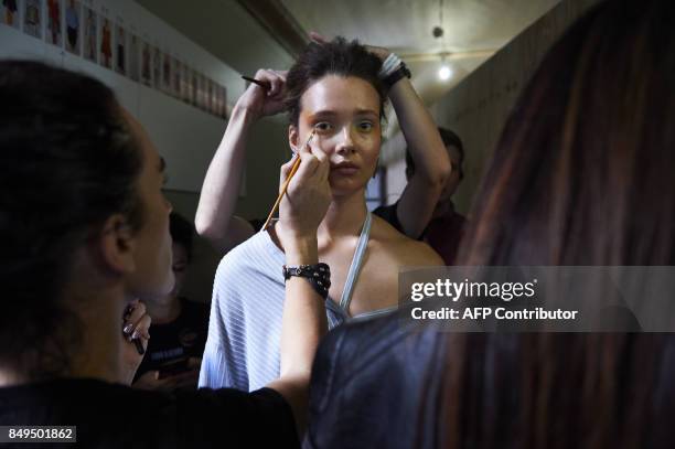 Stylists prepare models backstage ahead of the catwalk show of palmer//harding during the Spring/Summer 2018 collection on the fifth and final day of...