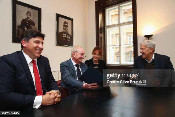 Rod Laver of Australia unveils a commemorative stamp with Martin Elkan , Director General of the Czech Post and former Czech player Jan Kodes ahead...