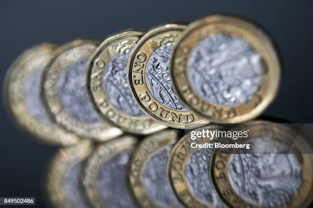 Row of one pound sterling coins stand in this arranged photograph in London, U.K., on Tuesday, Sept. 19, 2017. Strategists are revising their...