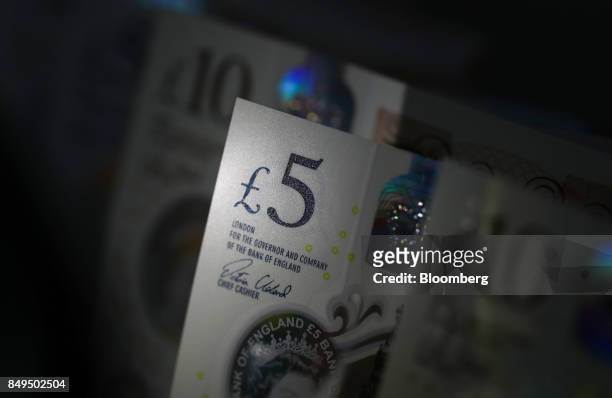 British five and ten pound banknotes stand in this arranged photograph in London, U.K., on Tuesday, Sept. 19, 2017. Strategists are revising their...