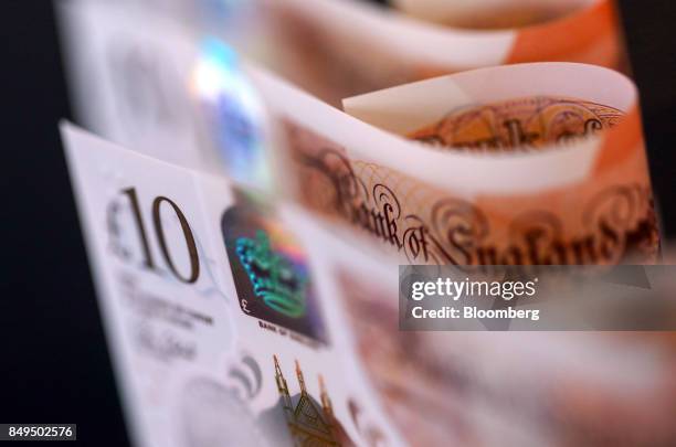 British ten pound banknotes stand in this arranged photograph in London, U.K., on Tuesday, Sept. 19, 2017. Strategists are revising their estimates...