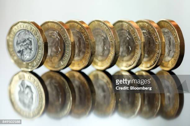 Row of one pound sterling coins stand in this arranged photograph in London, U.K., on Tuesday, Sept. 19, 2017. Strategists are revising their...