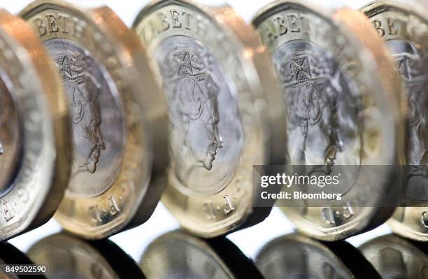 Row of one pound sterling coins stand in this arranged photograph in London, U.K., on Tuesday, Sept. 19, 2017. Strategists are revising their...