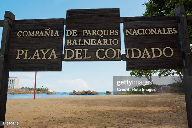 signboard on the beach, condado beach, san juan, puerto rico - condado beach stock pictures, royalty-free photos & images