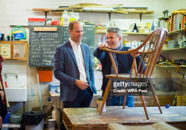 Prince William, Duke of Cambridge speaks with volunteer and former client Bernard Bristow during a visit to the Spitalfields Crypt Trust in St...