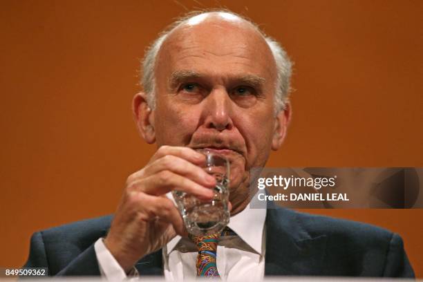 Britain's leader of the Liberal Democrats, Vince Cable takes a drink as he delivers his Keynote Speech at the party's annual conference in...