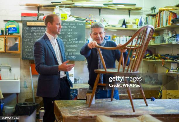 Prince William, Duke of Cambridge speaks with volunteer and former client Bernard Bristow during a visit to the Spitalfields Crypt Trust in St...