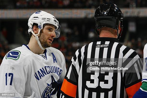 Ryan Kesler of the Vancouver Canucks speaks with referee Kevin Pollock during the game against the Ottawa Senators on February 19, 2009 at the...