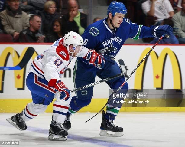 Saku Koivu of the Montreal Canadiens keeps Sami Salo of the Vancouver Canucks in check during their game at General Motors Place on February 15, 2009...