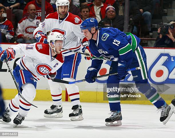 Mats Sundin of the Vancouver Canucks and Saku Koivu of the Montreal Canadiens react after the face-off during their game at General Motors Place on...