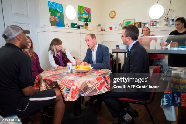 Britain's Prince William, Duke of Cambridge, talks with visitors in the cafe during his visit to the Spitalfields Crypt Trust, at St Leonard's Church...