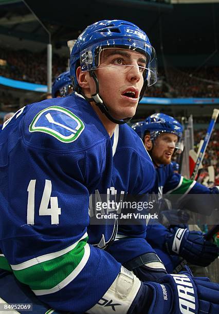 Alex Burrows of the Vancouver Canucks looks on from the bench during their game against the Montreal Canadiens at General Motors Place on February...