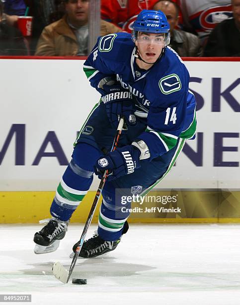 Alex Burrows of the Vancouver Canucks skates up ice with the puck during their game against the Montreal Canadiens at General Motors Place on...