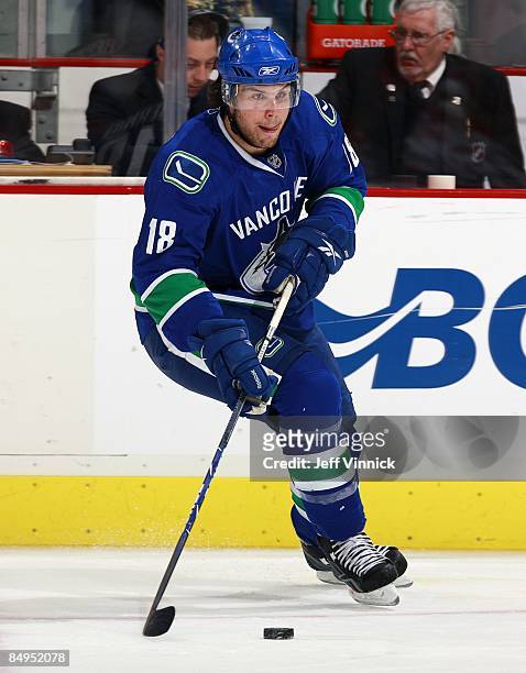 Steve Bernier of the Vancouver Canucks skates up ice with the puckÊduring their game against the Montreal Canadiens at General Motors Place on...