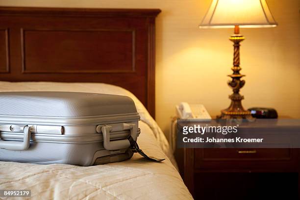 suitcase on bed in hotel room - hotel suite stock pictures, royalty-free photos & images