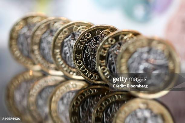 Row of one pound sterling coins stand in this arranged photograph in London, U.K., on Tuesday, Sept. 19, 2017. Strategists are revising their...