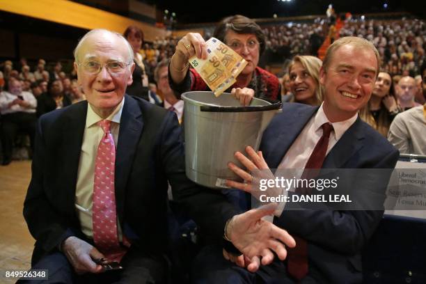 Former Liberal Democrat leaders Menzies Campbell and Tim Farron take a collection of 100 Euros towards the party fund at the party's annual...