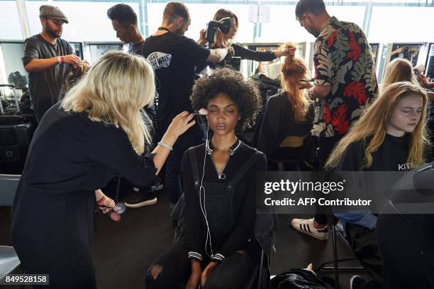 Models are prepared by stylists backstage ahead of the catwalk show by Turkish designer Bora Aksu, for his Spring/Summer 2018 collection on the first...