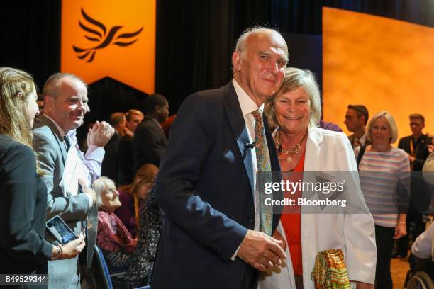 Vince Cable, leader of the U.K.'s Liberal Democrat Party, left, embraces his wife Rachel Smith, after delivering his keynote speech at the party's...