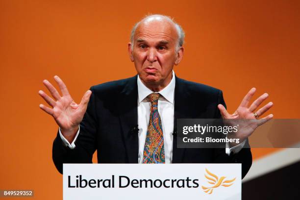 Vince Cable, leader of the U.K.'s Liberal Democrat Party, gestures while delivering his keynote speech at the party's annual conference in...