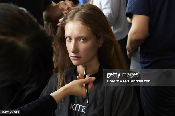 Models are prepared by stylists backstage ahead of the catwalk show by Turkish designer Bora Aksu, for his Spring/Summer 2018 collection on the first...