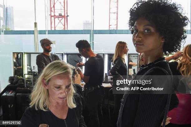 Models are prepared by stylists backstage ahead of the catwalk show by Turkish designer Bora Aksu, for his Spring/Summer 2018 collection on the first...