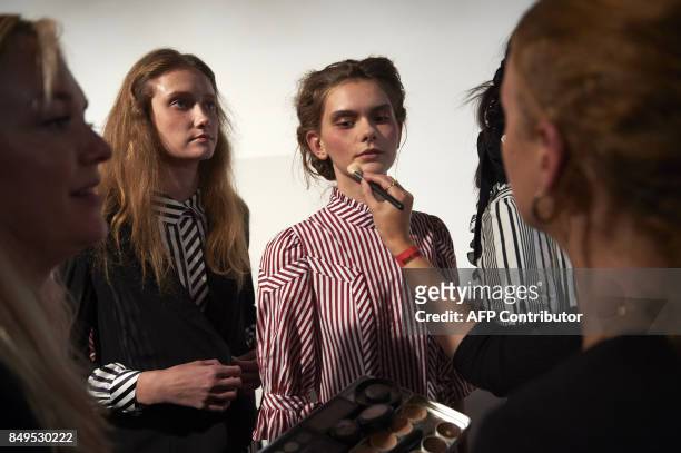Models are prepared by stylists backstage ahead of the catwalk show by Turkish designer Bora Aksu, for his Spring/Summer 2018 collection on the first...