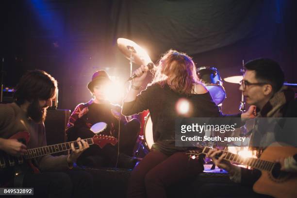 rock band performing in the club - acoustic guitarist stock pictures, royalty-free photos & images