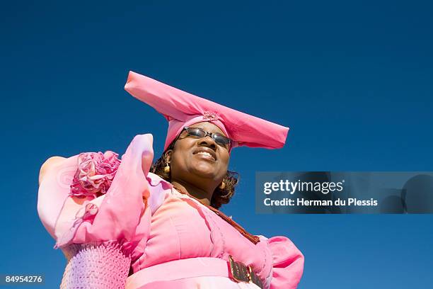 low angle view of woman in traditional herero dress, opuwo, kaokoland, namibia - opuwo tribe foto e immagini stock