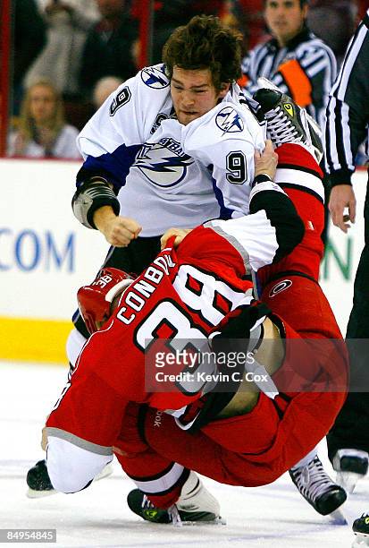 Steve Downie of the Tampa Bay Lightning knocks Tim Conboy of the Carolina Hurricanes down to the ice during the game on February 20, 2009 at RBC...