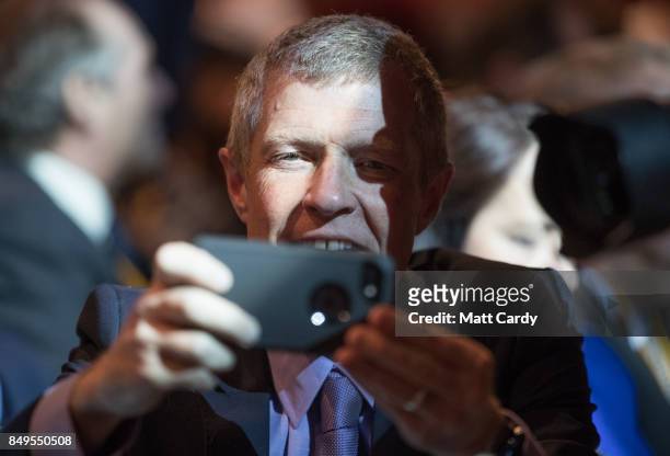 Scottish Liberal Democrat leader Willie Rennie takes a photograph as leader Vince Cable delivers his keynote speech during the final day of the...