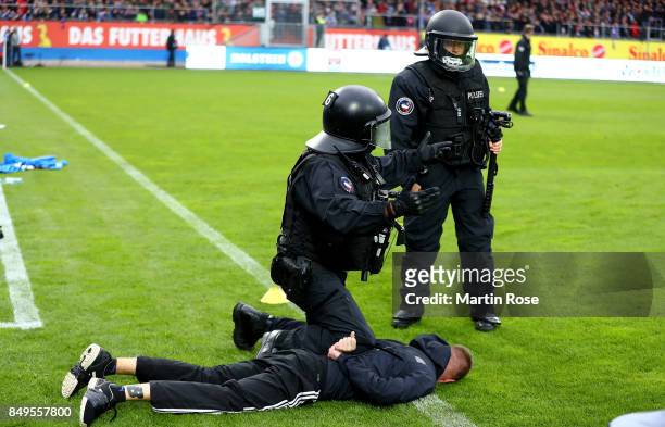Supporter of Kiel is atrrested by the police before the Second Bundesliga match between Holstein Kiel and FC St. Pauli at Holstein-Stadion on...