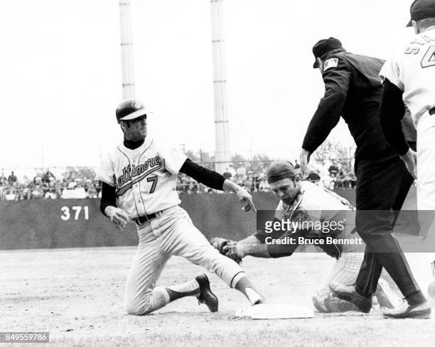 Mark Belanger of the Baltimore Orioles gets back to first before catcher Jerry Grote of the New York Mets gets the tag on him as umpire Lee Weyer is...