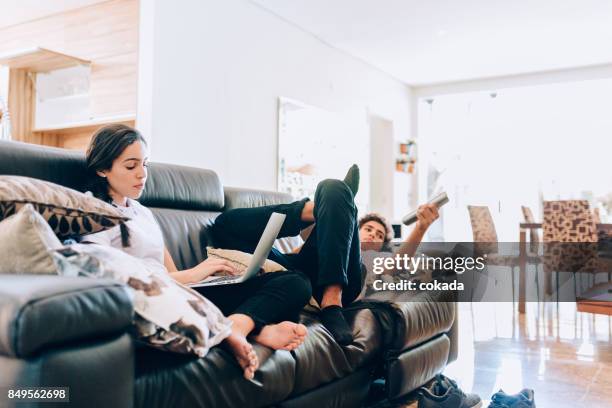 brother and sister spending time in the living room - teen girl barefoot at home stock pictures, royalty-free photos & images