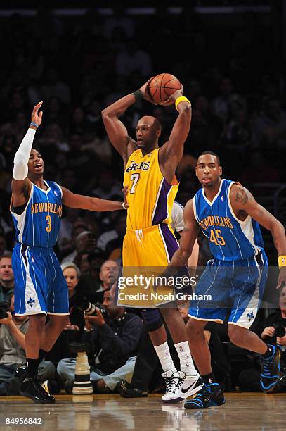 Lamar Odom of the Los Angeles Clippers looks to pass against Chris Paul and Rasual Butler of the New Orleans Hornets at Staples Center on February...