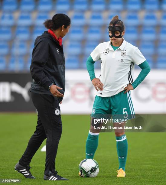 Coach Steffi Jones of Germany speaks to Babett Peter prior the 2019 FIFA Women's World Championship Qualifier match between Czech Republic Women's...