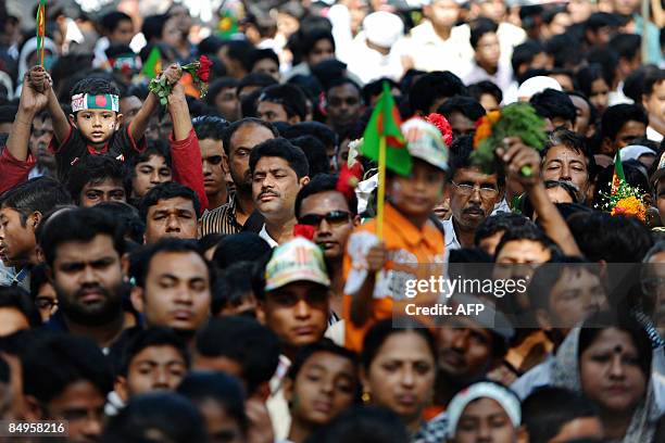 Bangladeshis participate in a rally near the monument for Bangladesh's Language Movement martyrs in Dhaka on February 21 to pay homage to the martyrs...