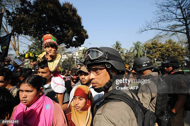 Bangladeshi security personnel stand guard during a rally near the monument for Bangladesh's Language Movement martyrs in Dhaka on February 21 to pay...