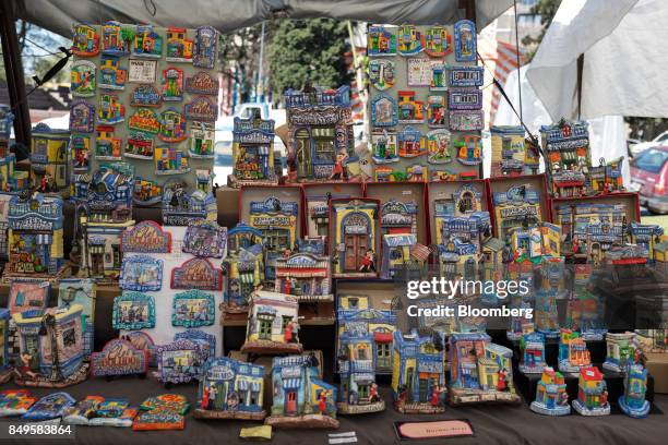 Souvenirs sit on display for sale at a vendor stall in the Plaza Francia market in Buenos Aires, Argentina, on Sunday, Sept. 17, 2017. The National...