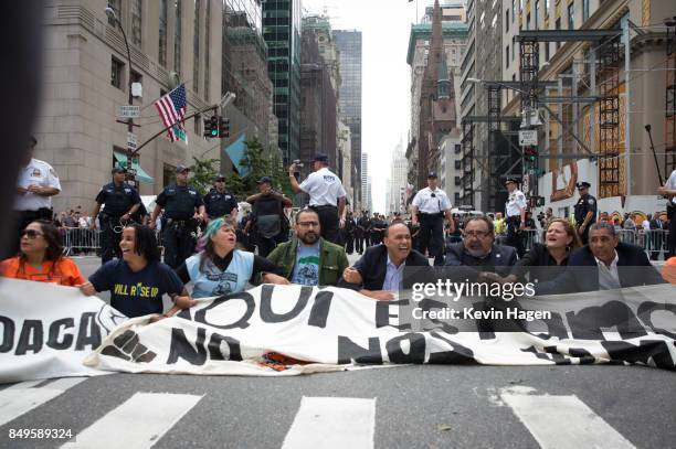 Activists sit on Fifth Avenue in an action of civil disobedience near Trump Tower on September 19, 2017 in New York, New York. The action was...